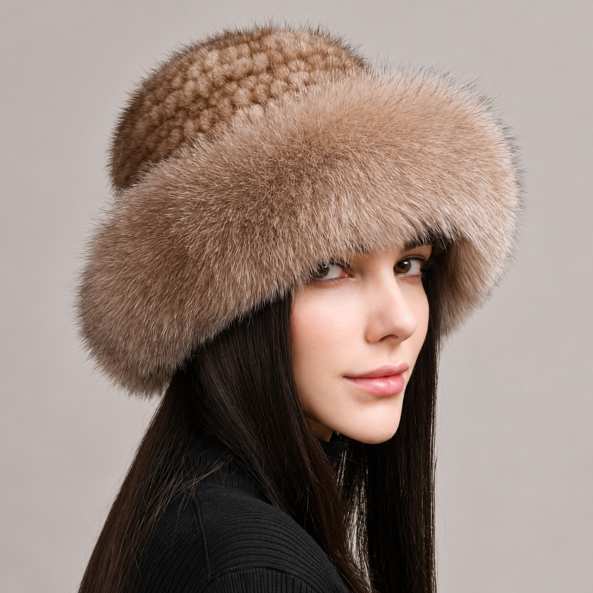 Light beige knitted mink hat with a fluffy fox fur brim, shown from the front on a model.