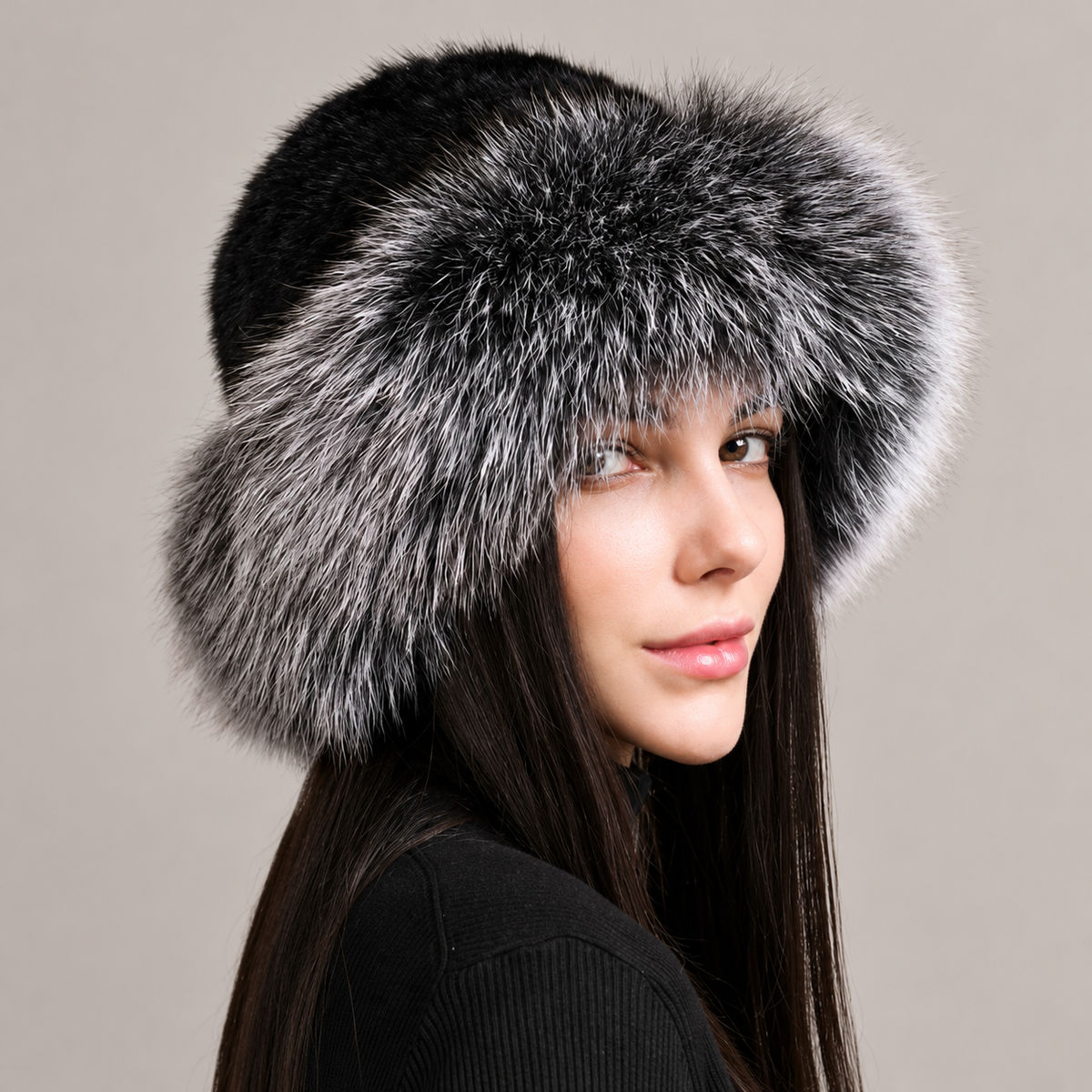 Black and silver fox fur brim hat with a dark knitted mink crown, shown from the side on a model.