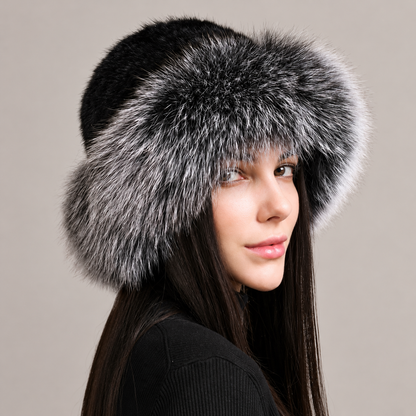 Black and silver fox fur brim hat with a dark knitted mink crown, shown from the side on a model.