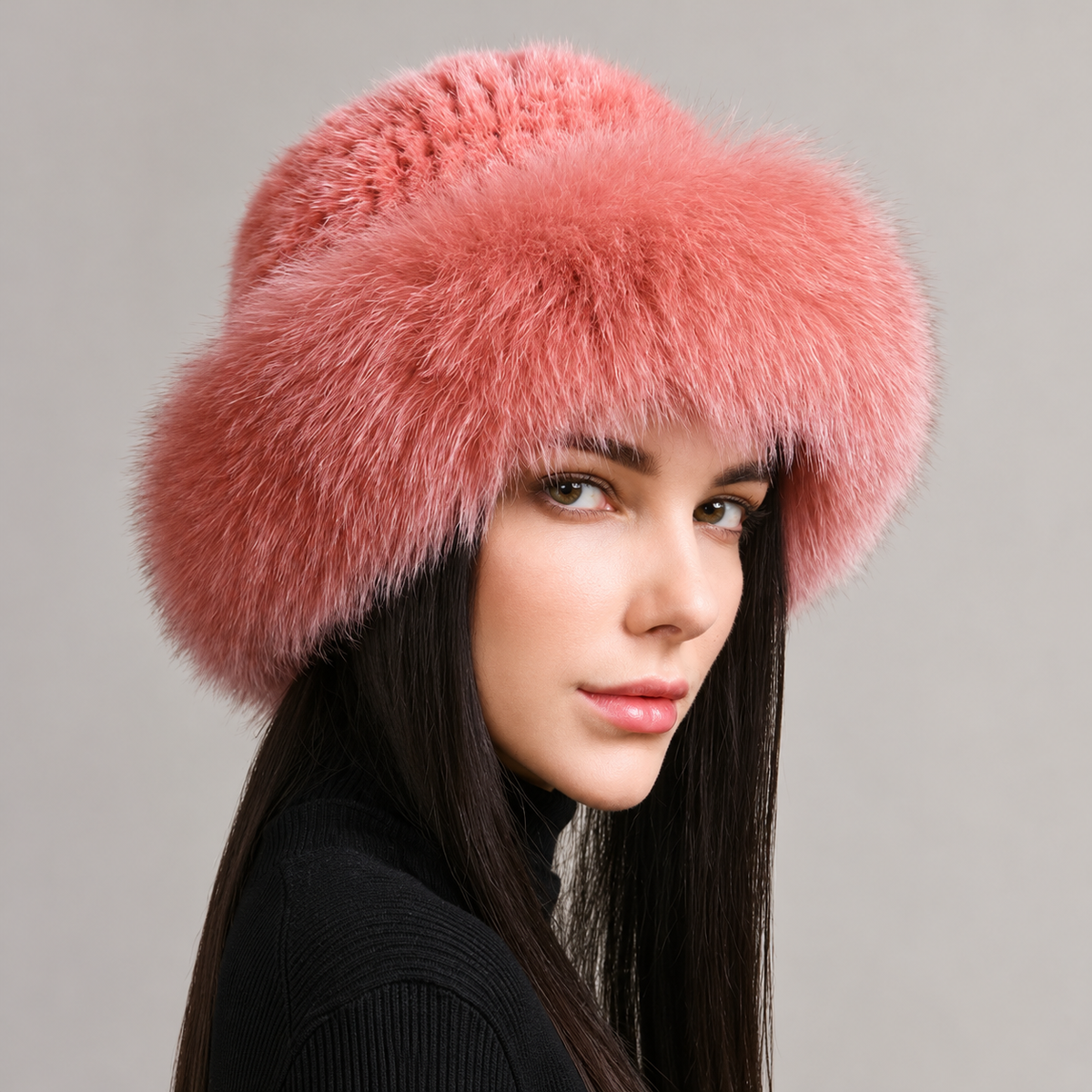 Pink knitted mink hat with a fluffy fox fur brim, shown from the side on a model.