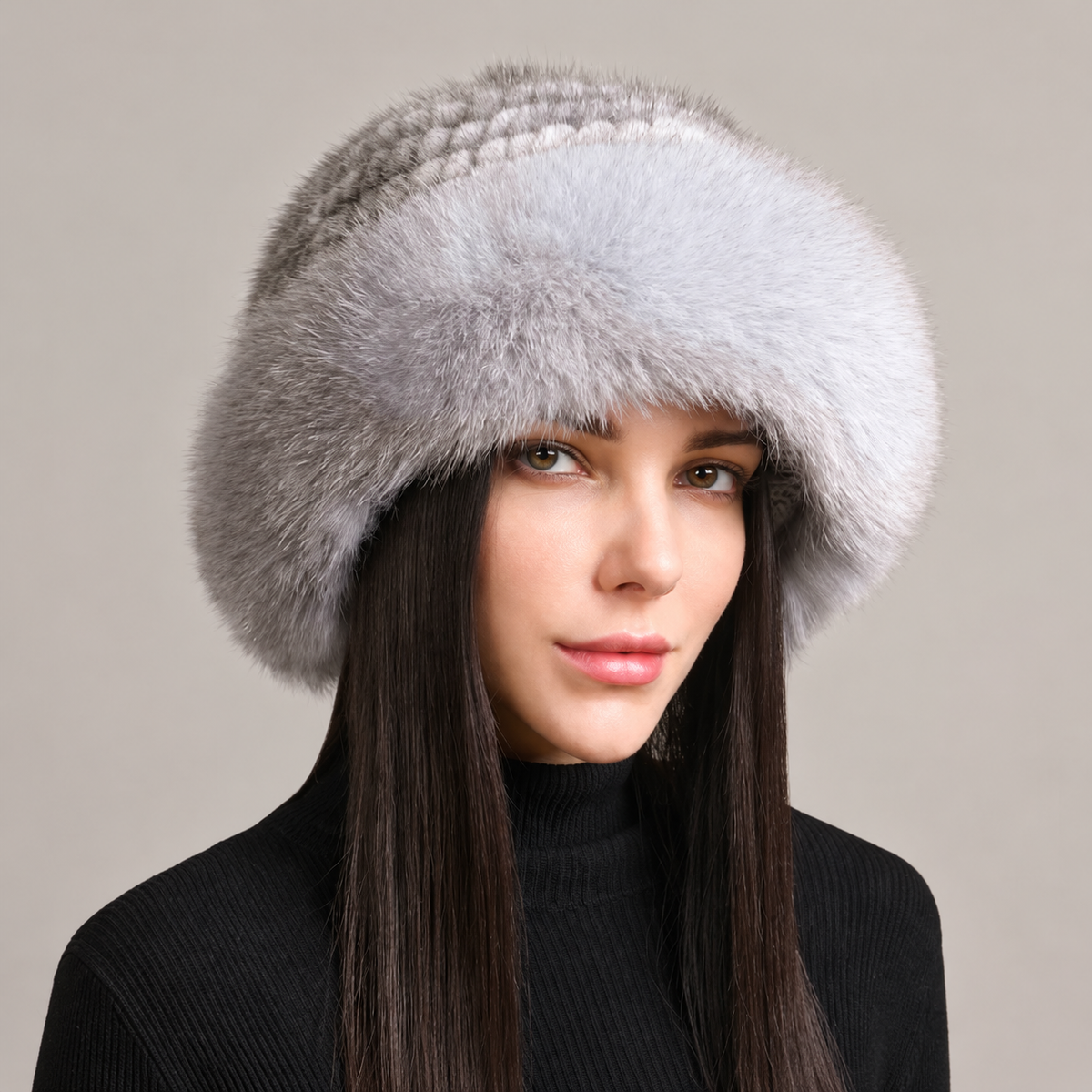 Silver gray knitted mink hat with a fluffy fox fur brim, shown from the front on a model.