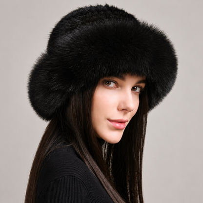 Black knitted mink hat with a wide fox fur brim, shown from the side on a model.