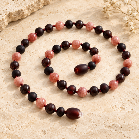 Cherry Baltic amber sunstone and garnet necklace on beige stone