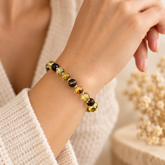 Green Baltic amber bracelet worn on adult wrist