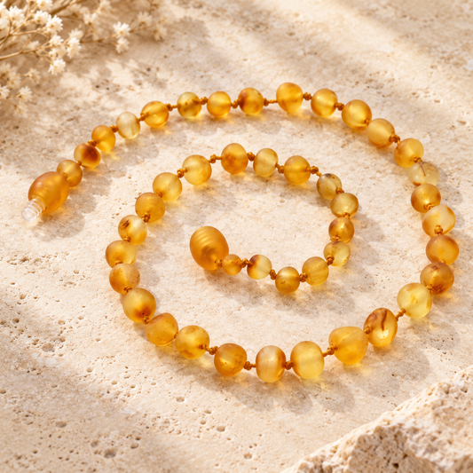 Raw honey Baltic amber necklace on beige stone