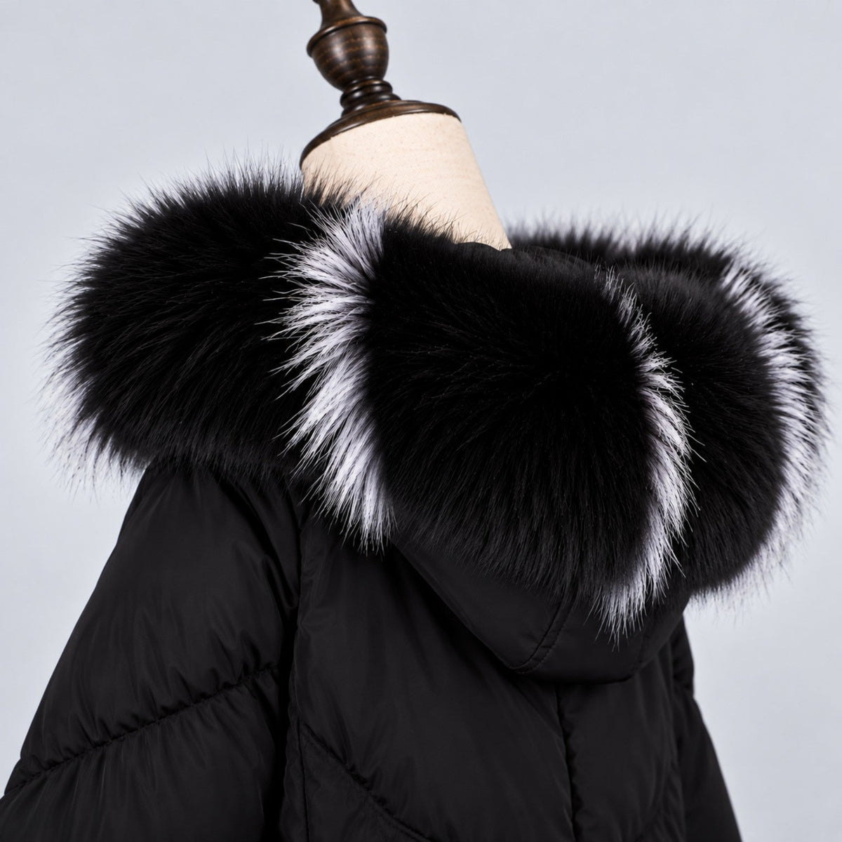Black fox fur hood trim with white silver accents on black coat