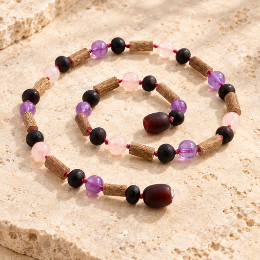 Hazelwood amber cherry and gemstone necklace on beige stone