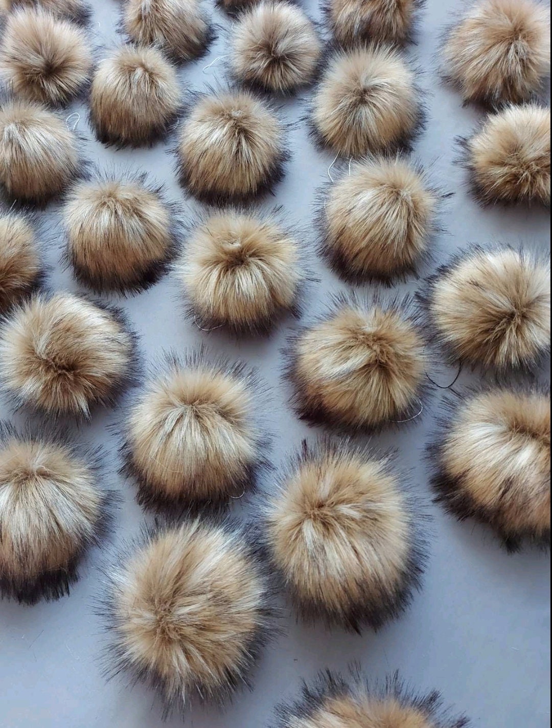 Large faux raccoon fur pom poms for hats and crafts – front view