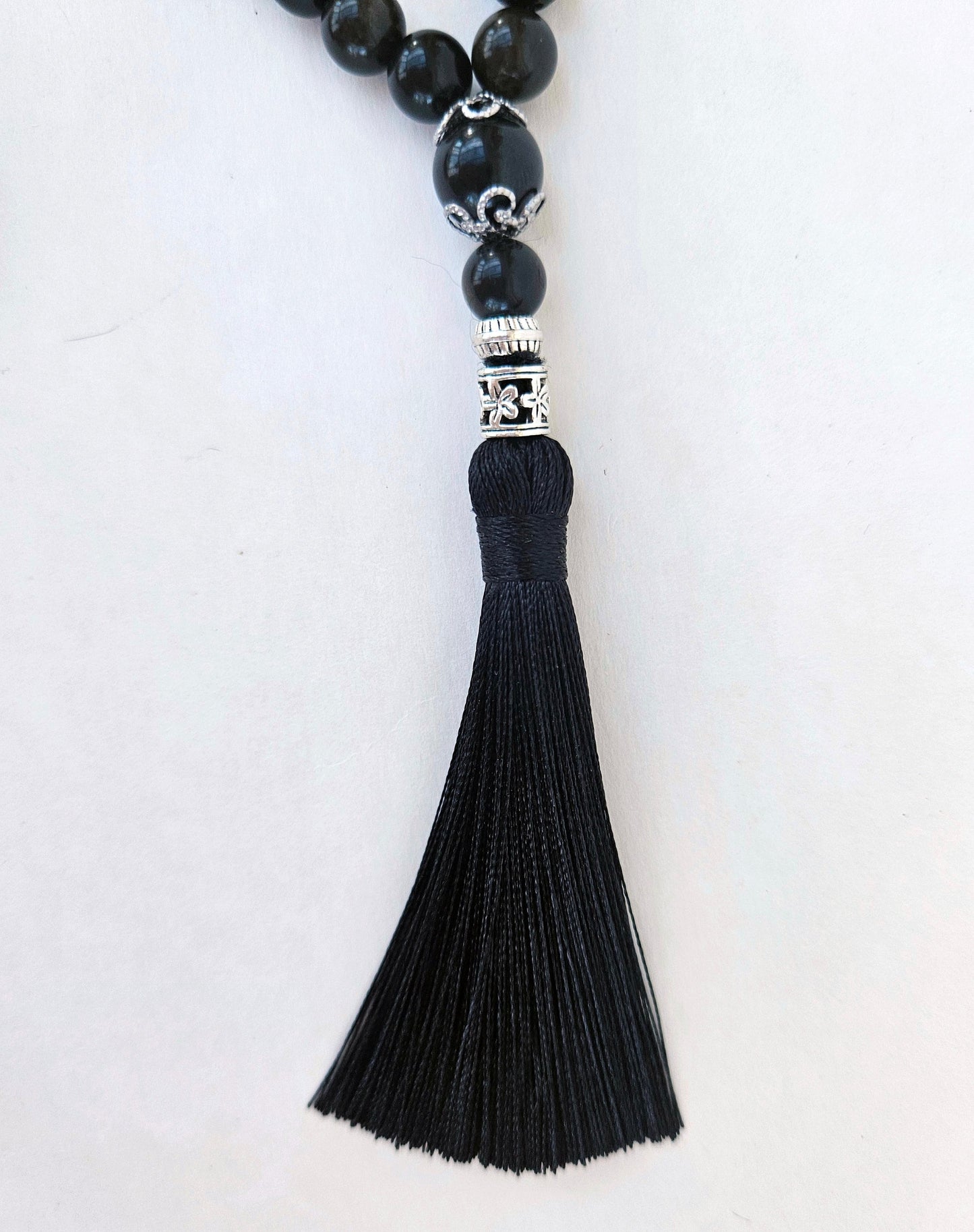 At the end of the rosary there is a  3-inch silk tassel serves as a pendant.