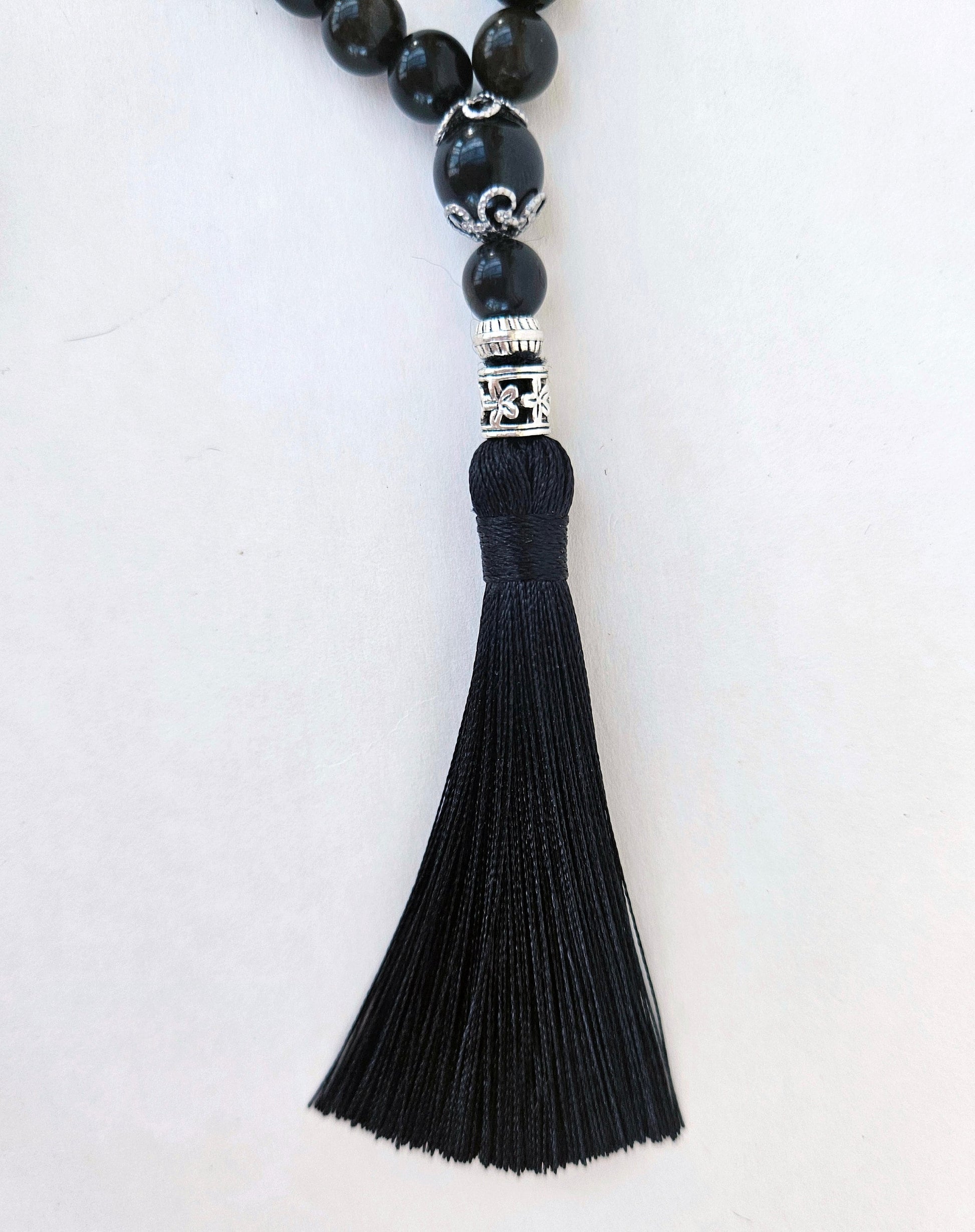 At the end of the rosary there is a  3-inch silk tassel serves as a pendant.