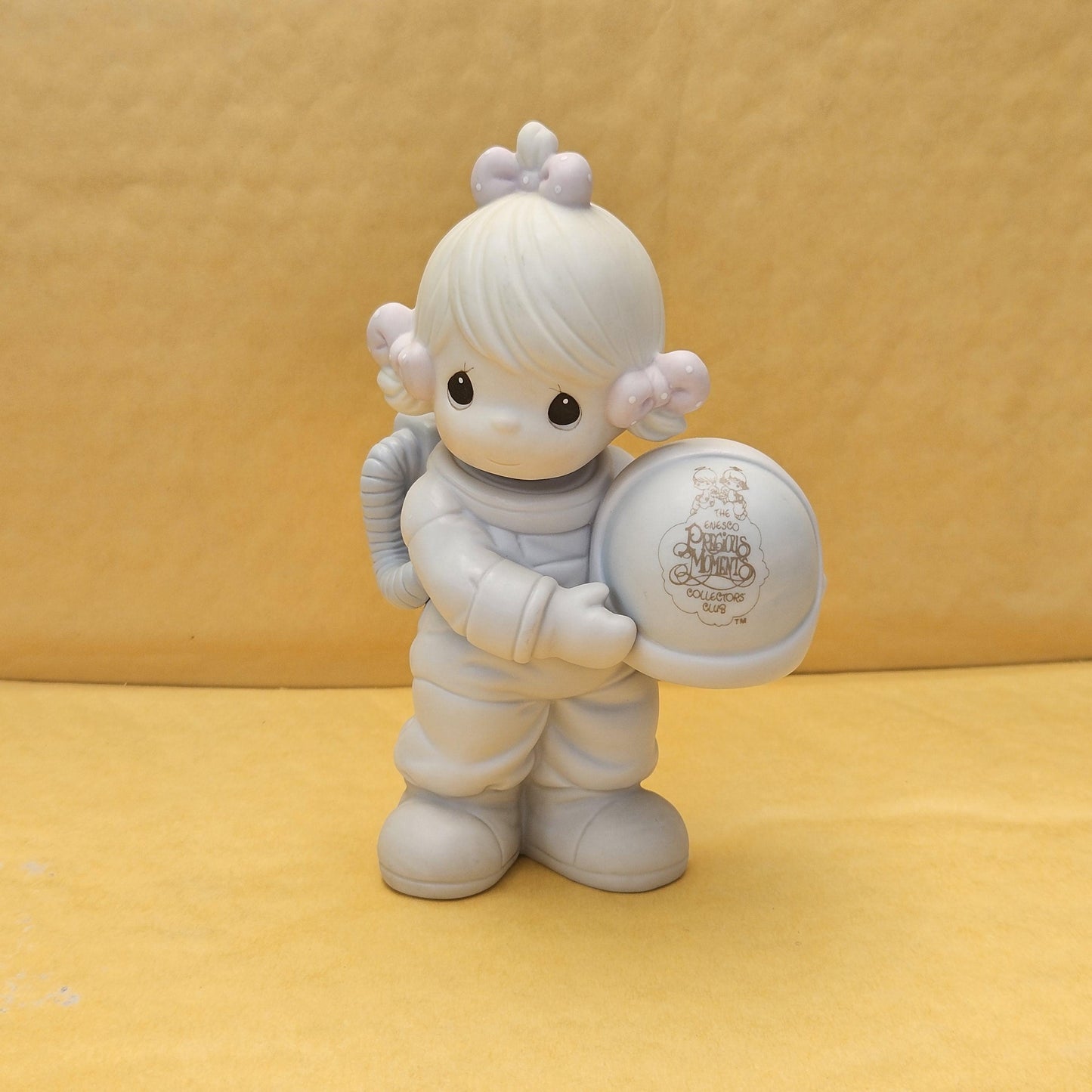 ** The Club Thats Out of This World**
- Measures approx. stands 5 inch tall
- Produced in 1991 (Samuel J. Butcher)
- Model #C0012
-  Features a charming character holding a space helmet
- Great condition, no chips or cracks. 
- hand-painted porcelain bisque