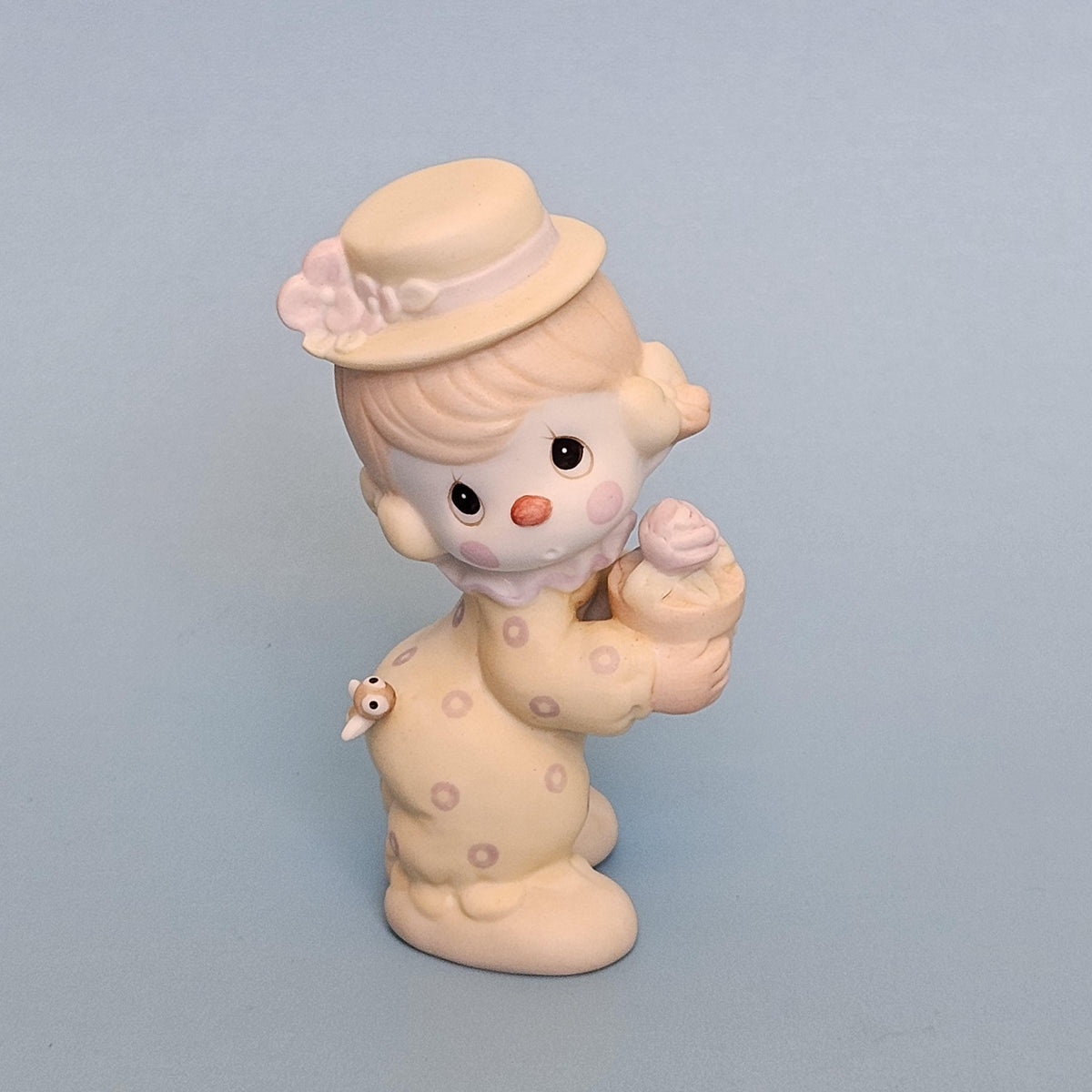 Precious Moments Clowns porcelain figurine holding a flower pot, front view