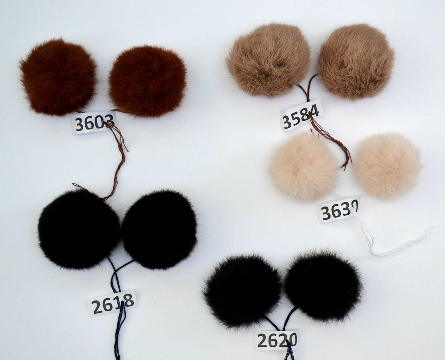 beige double rabbit pom poms, black double rabbit pom poms