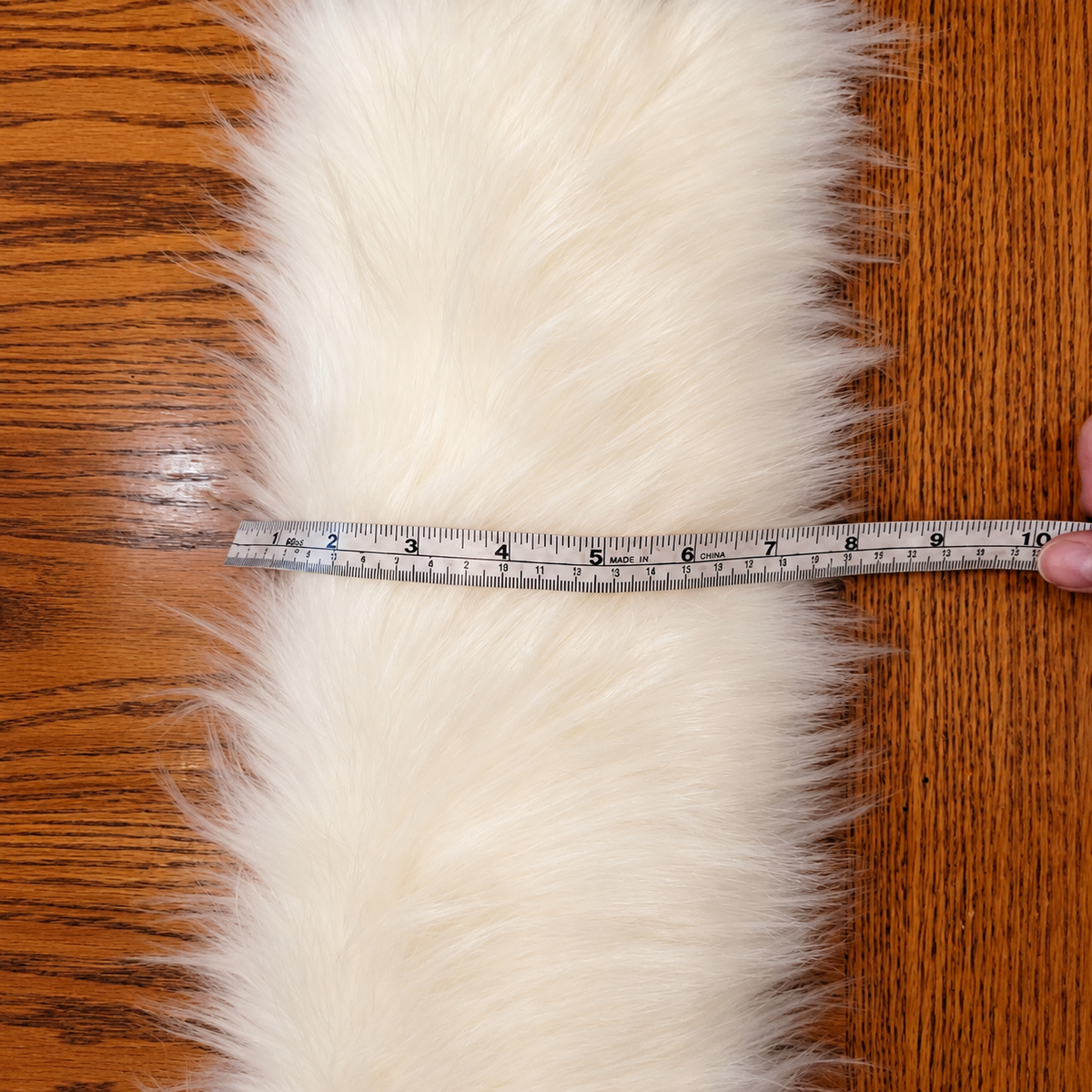 Warm ivory faux fur sample with ruler